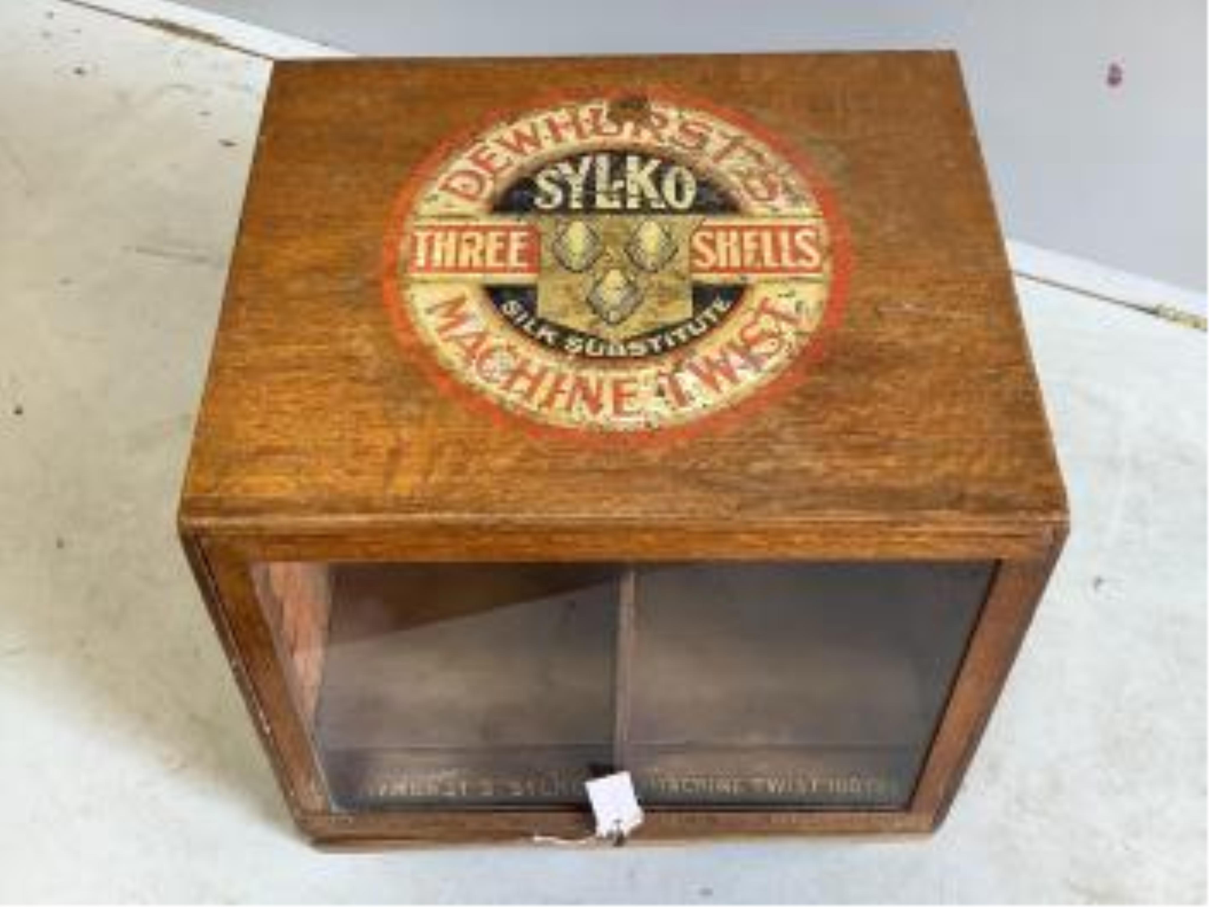 An early 20th century oak counter top display case, 'Dewhursts Sylko three shells machine twist' on revolving base, width 54cm, depth 53cm, height 43cm. Condition - fair